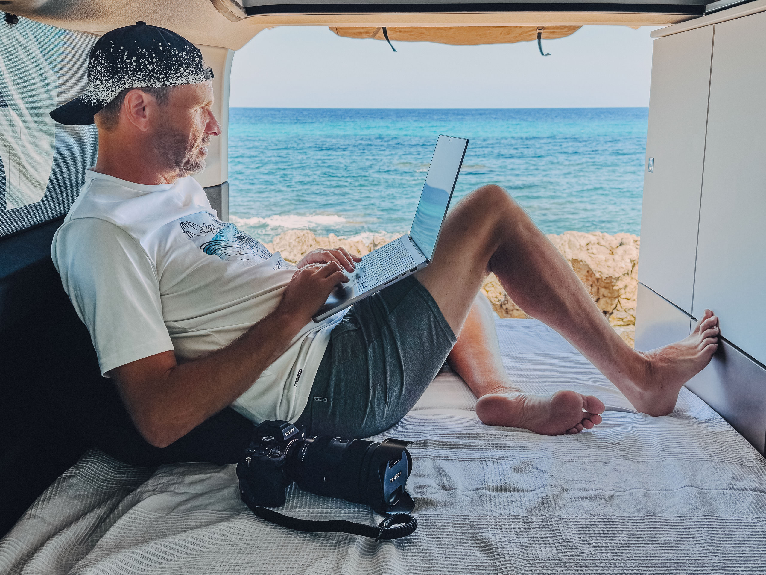 Dirk works in the van with a view of the sea